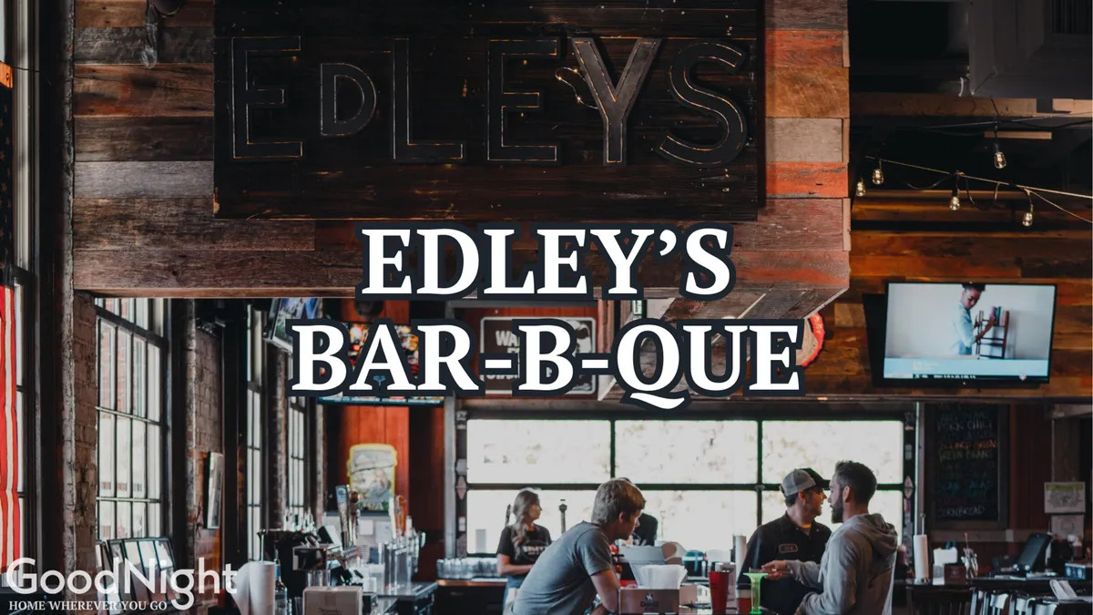 The interior of a lively bar or BBQ spot featuring the 'EDLEY’S BAR-B-QUE' sign, bustling bar area, and patrons dining, socializing, and watching sports. The ambiance is casual and energetic, with a clear focus on group dining and shared experiences.